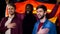 Multiracial german football fans singing anthem, holding flag in bar, supporters