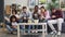 Multiracial group of friends using smartphones touching screen on sofa at home