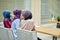 Multiracial group of muslim women dressed in national clothes posing in group