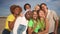 Multiracial group of people smiling taking a selfie outdoors