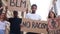 A multiracial group of students protests against racism. Boys and girls are holding placards with the words no racism