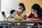 Multiracial high school students wearing a face mask in class taking an exam