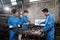 Multiracial industry workers` teams discuss mechanical drawings on a monitor