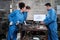 Multiracial industry workers` teams discuss mechanical drawings on a monitor