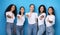 Multiracial Ladies Gesturing Thumbs-Up Posing In Studio On Blue Background