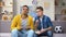 Multiracial male teen friends discussing football match eating popcorn, leisure