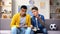 Multiracial male teen friends discussing football match eating popcorn, leisure