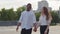 Multiracial multiethnic couple afro american man guy husband and caucasian woman girl wife girlfriend walk down street