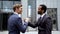 Multiracial partners shaking hands after successful deal, teamwork in startup