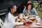 Multiracial people eating at food truck restaurant outdoor - Focus on african woman face