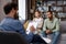 Multiracial quarrel between husband and wife at a session with a psychotherapist. A visit to a family psychologist for a