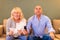 Multiracial senior couple fans cheering for soccer football