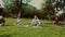 Multiracial senior people doing yoga meditation in a public park