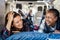 Multiracial senior women friends having fun camping inside camper van - Focus on right african woman eye