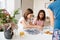 Multiracial sisters doing puzzle together with their mother