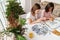 Multiracial sisters talking and doing puzzle together