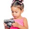 Multiracial small girl holding a compact camera