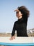 Multiracial surfer girl portrait watching the waves