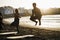 Multiracial surfer people doing warm up at the beach - Focus on center man