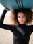 Multiracial surfer young woman with afro hair portrait holding surboard