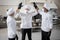 Multiracial team of chefs giving five with hands before a job on kitchen