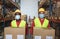 Multiracial warehouse coworkers holding delivery boxes while wearing safety mask for coronavirus prevention - Focus on faces
