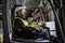 Multiracial warehouse worker driving forklift. Warehouse worker preparing products for shipmennt, delivery, checking