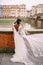 Multiracial wedding couple. Wedding in Florence, Italy. African-American bride and Caucasian groom stand embracing on