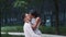 Multiracial woman and man in love spinning around, kissing and talking