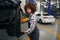 Multiracial woman repairman inspecting a car wheel