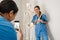 Multiracial women doctors taking photo with skeleton on cellphone