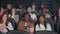 Multiracial young adults watching comedy in cinema.