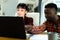 Multiracial young couple discussing household expense budget over laptop at home