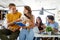 Multiracial young people enjoying group study at table.