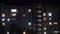 Multistorey building with changing window lighting at night. Time lapse