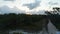 Multistorey buildings surrounded by forested area. Pedestal reveal shot during sunset