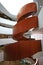 Multistory indoor atrium with suspended wood spiral stairs like dancing ribbon at University of Sydney Business School, Australia