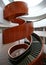 Multistory indoor atrium with suspended wood spiral stairs like dancing ribbon at University of Sydney Business School, Australia