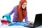 Multitasking young woman wearing hijab watching movie on laptop