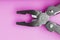 Multitool is a multi-functional tool on a pink background. The concept of an open, flying multi-tool with free space
