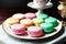 A multitude of macarons graces a plate, elegantly positioned on a tabletop.