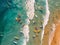 multitude of surfers in the sea seen from above, aerial image of the sea with colored surf in the waves, holidays, created with ai