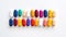 A multitude of vibrant pills scattered on a white background