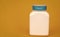 multivitamin bottle on yellow background. copy space. food supplement.