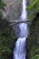 Multnomah Falls and foot bridge in lush green setting near Mount Hood and Portland Oregon in the Columbia River Gorge region