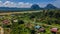 Mulu village with houses and roads surrounded by tropical forest and mountains near Gunung Mulu national park. Borneo. Sarawak.