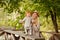 Mum gently embraces the redhead baby girl and laughing in autumn