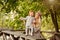 Mum gently embraces the redhead baby girl and laughing in autumn