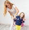 Mum helps her daughter get ready for school