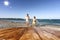 Mum and kid on the beach. Table background with beautiful blue ocean and sandy beach view. Summer sunny day.